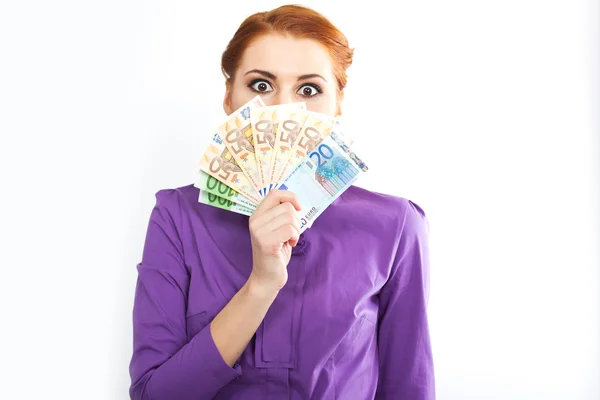 Young red-haired girl with euro banknotes. Portrait of slim girl in a bright shirt — Stock Photo, Image