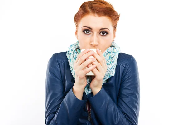 Young red-haired girl with a cup of hot coffee — Stock Photo, Image