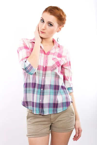 Young red-haired girl in surprise. Portrait of a slim girl. Isolated on white. teenage style — Stock Photo, Image