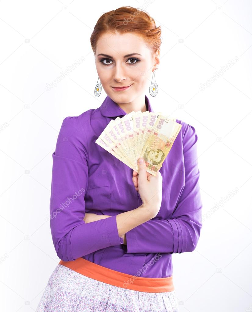 Business woman holding a UAH. recalculate the money. Exchange