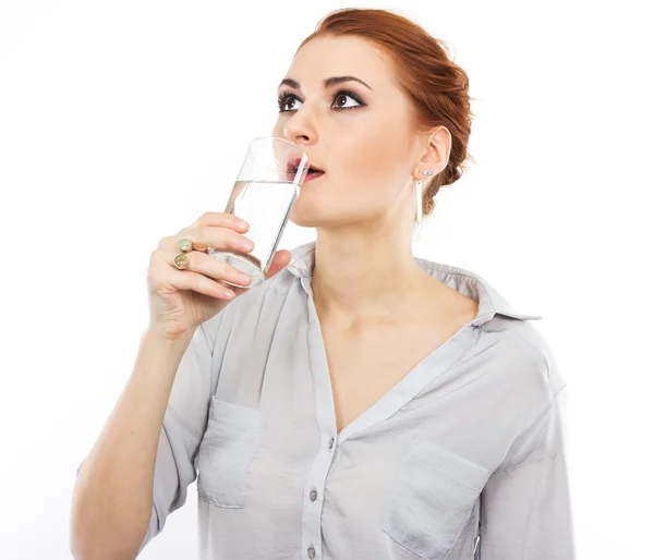 Happy young girl with a glass of water. A glass of water. Healthy life. Red-haired girl — Stock Photo, Image
