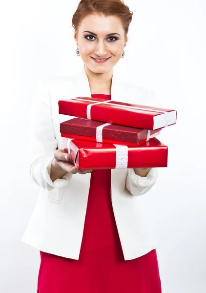 Young girl in red dress with gift red box. Beautiful red-haired girl on white. — Stock Photo, Image