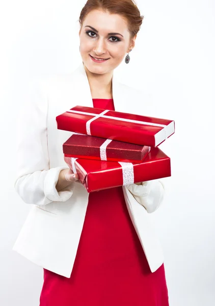 Young girl in red dress with gift red box. Beautiful red-haired girl on white. — Stock Photo, Image