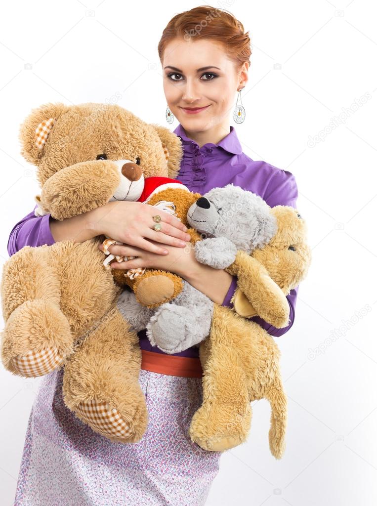 Young girl with a bunch of stuffed animals. Girl with soft toys on a white background