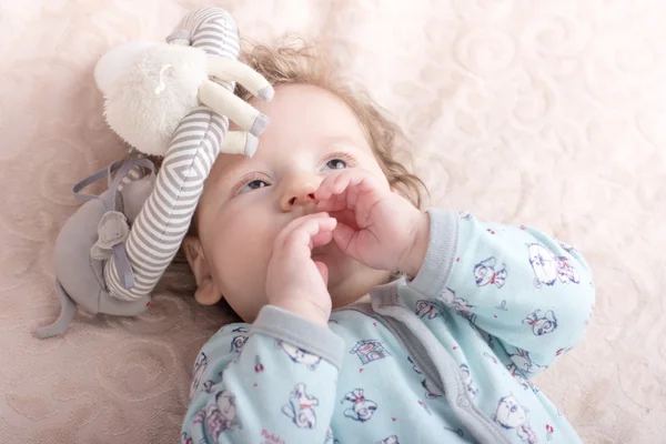 Beautiful baby with a lovely toys.The child in the crib — Stock Photo, Image