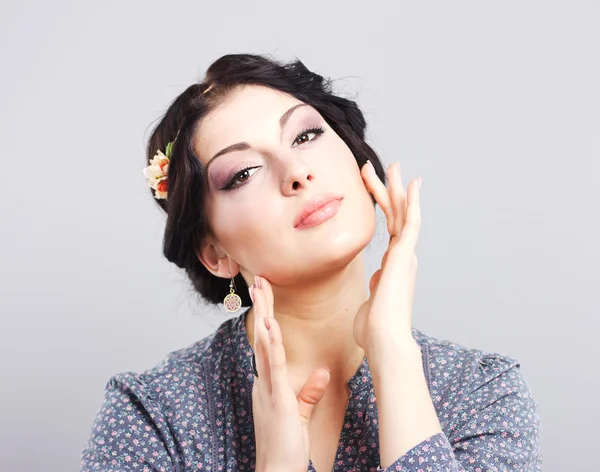 Linda morena em um fundo cinza. Menina cuida da pele.Estilo de cabelo. Maquiagem. lábios gordos — Fotografia de Stock