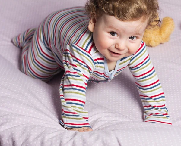 Beautiful baby with a lovely toys.The child in the crib — Stock Photo, Image