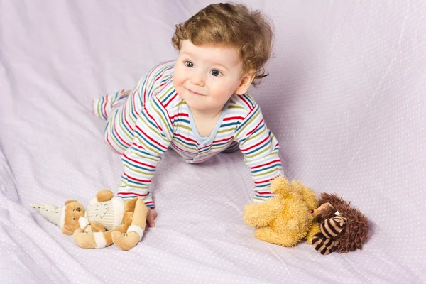 Portrait of a beautiful baby.Beautiful baby with a lovely toys.The child in the crib — Stock Photo, Image