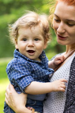 Young mother walking with a little boy. Child Outdoors.Mother and baby walk