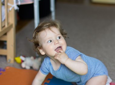 Funny baby playing with toys at home. Little smiling boy. Portrait-year-old child