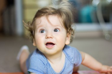 Funny baby playing with toys at home. Little smiling boy. Portrait-year-old child
