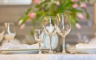 Wedding interior. Banquet. Festive table. Glasses of wine. flowers