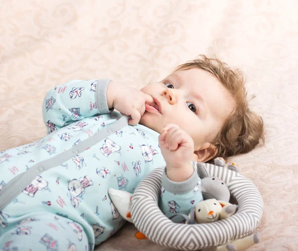 Beautiful baby with a lovely toys.The child in the crib — Stock Photo, Image