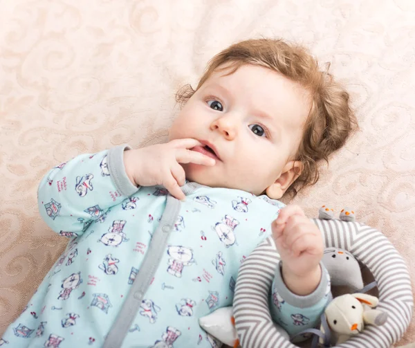 Beautiful baby with a lovely toys.The child in the crib — Stock Photo, Image