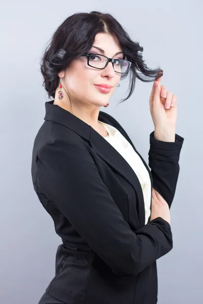 Business woman in a narrow black jacket. Successful woman. Beautiful brunette. Portrait of a beautiful girl in glasses — Stock Photo, Image