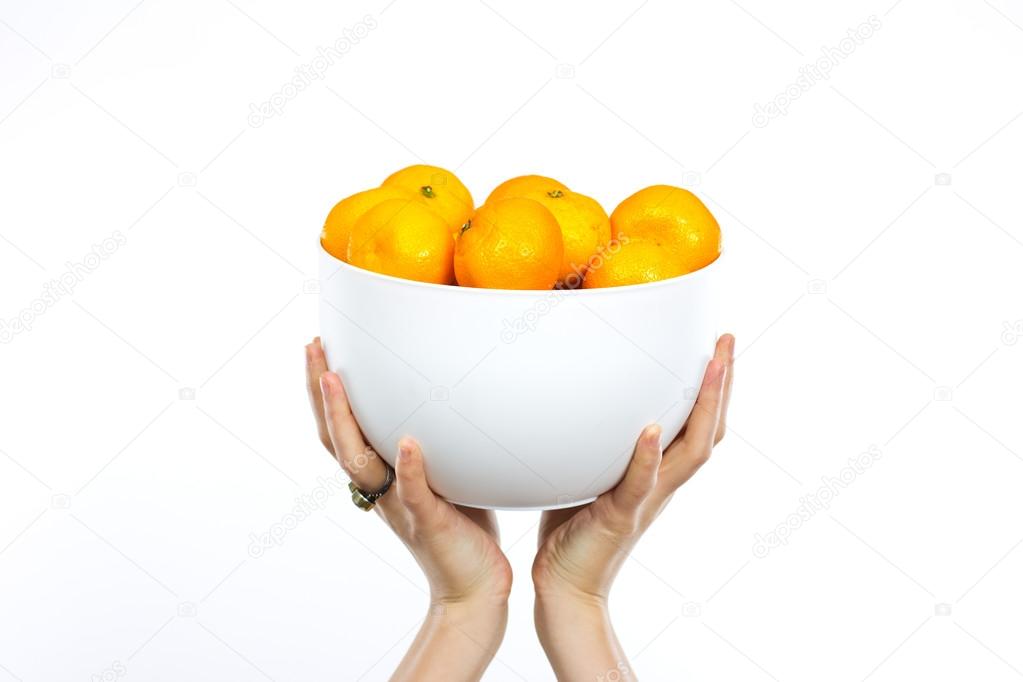 Young slim girl with tangerines. Portrait of a woman on a diet. Tasty and useful. Counting calories. Portrait of a girl isolated on a white