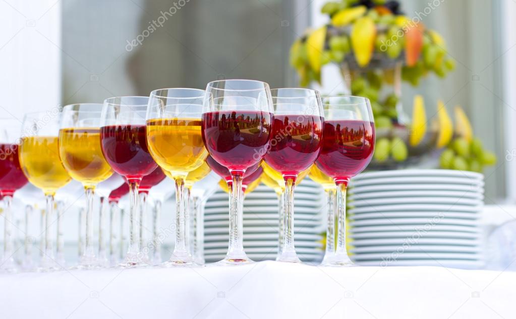 Wedding banquet outdoors. Wedding ceremony. Glasses of red and white wine. Glass of champagne