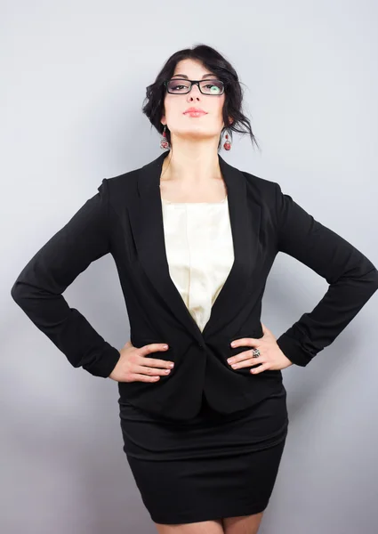 Business woman in a narrow black jacket. Successful woman. Beautiful brunette. Portrait of a beautiful girl in glasses — Stock Photo, Image