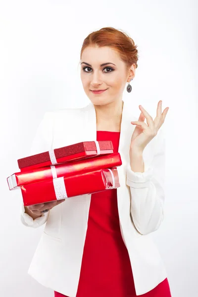 Young girl in red dress with gift red box. Beautiful red-haired girl on white. — Stock Photo, Image