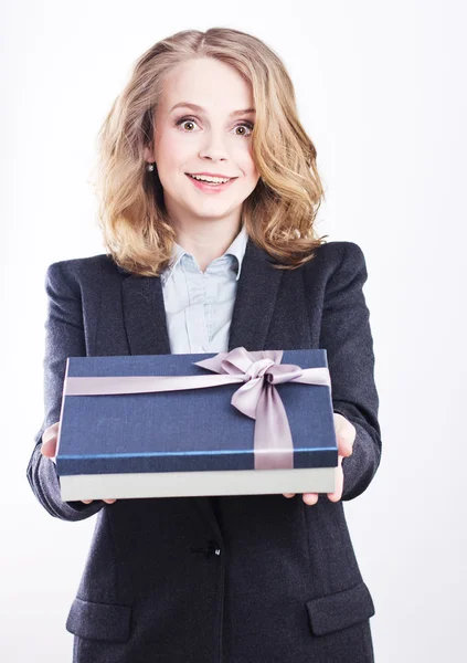 Mulher de negócios feliz com um presente. Retrato de uma loira em uma jaqueta em um branco . — Fotografia de Stock