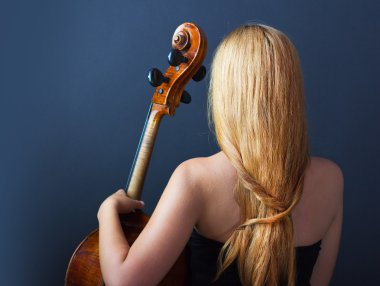 Beautiful girl with a cello on a black background. Cellist. Girl musician. clipart