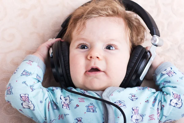 Bébé drôle dans un grand casque. Portrait d'un petit garçon. Enfant mignon . — Photo