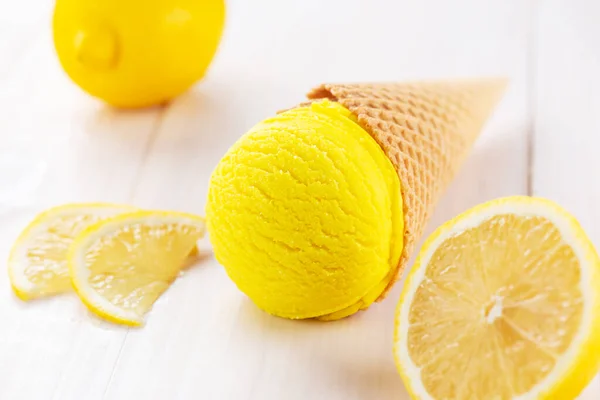 Yellow lemon ice cream on a wooden table.