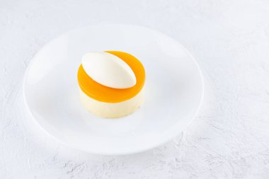 Mangolu kremalı pasta ve beyaz tabakta tutku meyvesi..