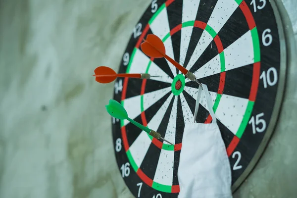 Close up face masks hanging on Dart board