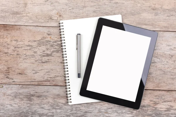 Tablet and notepad on a wooden desktop — Stock Photo, Image