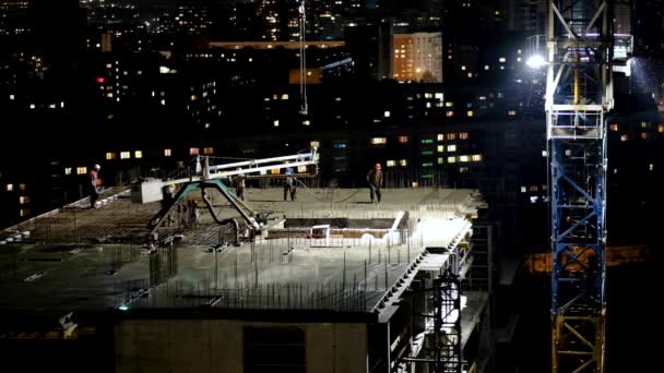 Trabajadores de la construcción vertiendo hormigón húmedo utilizando manguera de araña de hormigón o trabajo de bomba en el sitio de gran altura en la noche — Vídeos de Stock