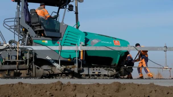 RUSSIA, Novosibirsk - May 30, 2020：Road construction works with roller compactor machine and asphalt finisher — 图库视频影像