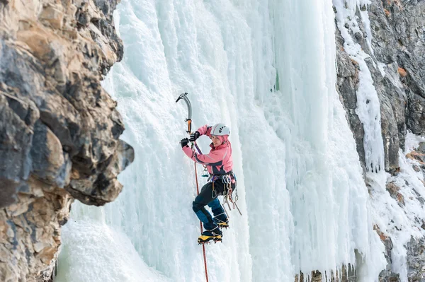 Donmuş şelale tırmanma ve gülümseyen kız dağcı — Stok fotoğraf