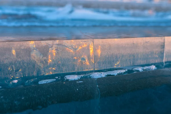 Slice of ice on the frozen lake at sunset — Stock Photo, Image