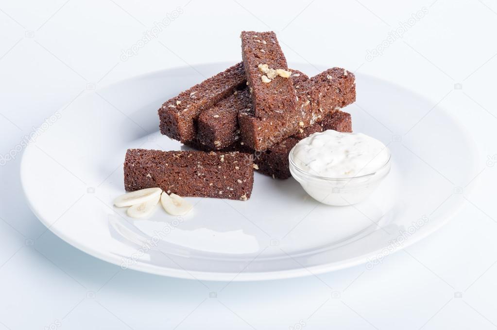 roasted garlic croutons, sour cream on a white background