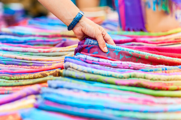 Woman chooses scarves in Turkish Bazaar. woman's hand