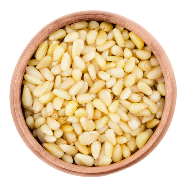 Shelled pine nuts in a bowl on white background — Stock Photo, Image