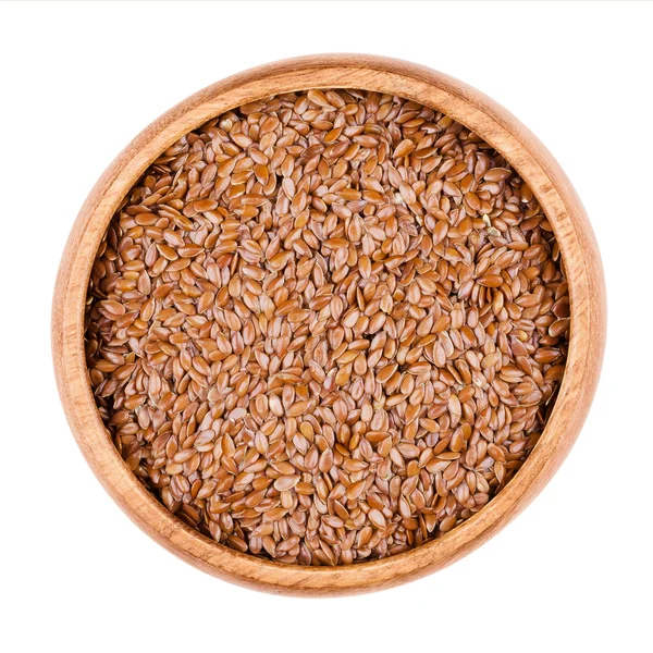 Brown flaxseeds a bowl on white background — Stock Photo, Image