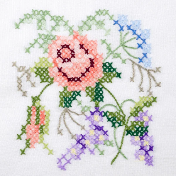 Çiçek motifi el nakış beyaz keten masa örtüsü üzerinde — Stok fotoğraf