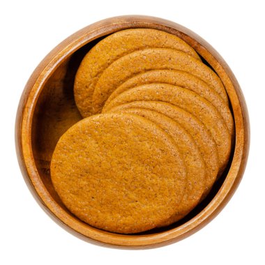Ginger snaps in a wooden bowl. Scandinavian ginger nuts. Thin, round shaped biscuits, flavoured with ginger, cinnamon, molasses and clove. Close-up, from above, isolated over white, macro food photo. clipart