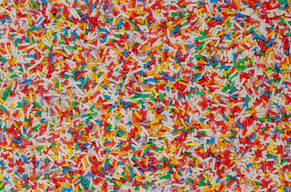 Regenboog Hagelslag Achtergrond Oppervlak Staafvormige Kleurrijke Suikerhagelslag Kleine Snoepjes Een — Stockfoto