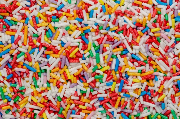 Tęczowe Posypki Tło Powierzchnia Kolorowe Posypki Cukru Kształcie Pręta Malutkie — Zdjęcie stockowe