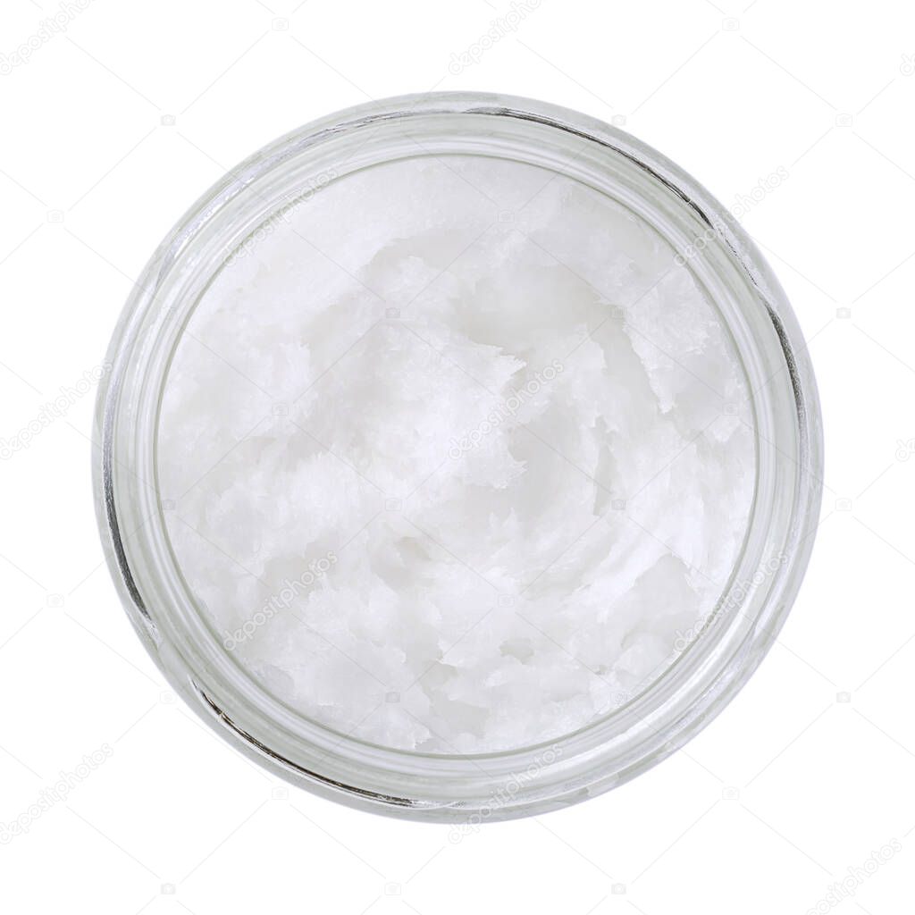 Coconut oil in a glass jar. Unrefined coconut butter, an edible oil, derived from the wick, meat, and milk of the coconut palm fruit. White solid fat, melting at warmer room temperatures. Food photo.