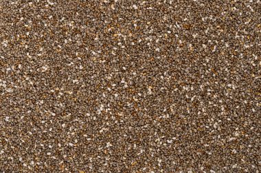 Chia tohumları, arka plan, yukarıdan. Salvia Hispanica meyveleri. Oval ve gri meyveler, siyah ve beyaz benekli, çok higroskopik, yiyeceklere ayırt edici bir jel yapısı veriyor. Arkaplan. Makro yemek fotoğrafı..