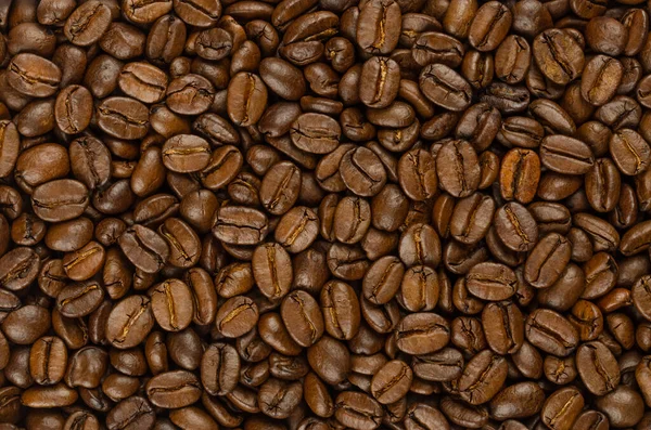 Rostade Kaffebönor Bakgrund Uppifrån Mörkbruna Rostade Bär Från Coffea Arabica — Stockfoto