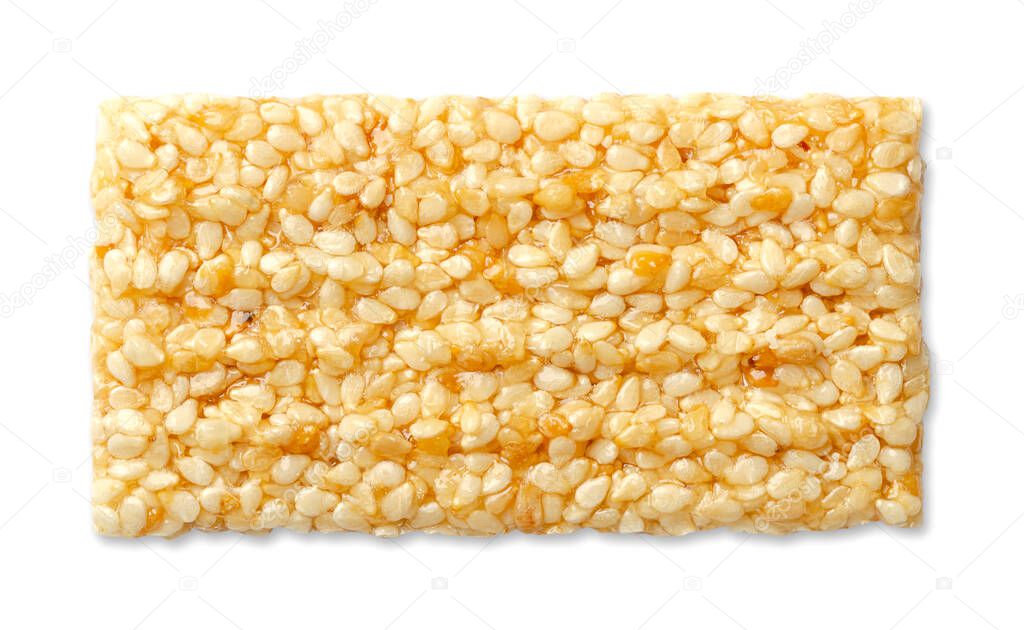 Sesame brittle bar, from above, on white background. Single sesame seed candy bar, also called crunch, a confection of sesame seeds and honey, pressed into flat bars. Popular snack in the Middle East.