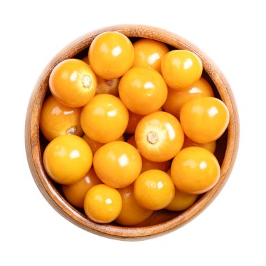 Altın çilek, bektaşi üzümü, ahşap bir kasede. Ayrıca Peru yerkirazı olarak da adlandırılır, taze, olgun ve parlak turuncu meyveler Physalis Peruviana, sonra kağıt fener benzeri dış kaplama kaldırıldı.