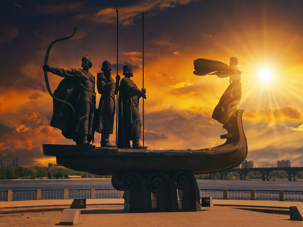 Bronze monument to Founders of Kiev. Kyi, Horyv, Shchek and Lybid by the Dnieper River during beautiful sunset in Kiev, Ukraine. Popular myth of Ukrainian culture.