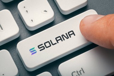 Male finger pressing computer key with Solana token logo. Cryptocurrrency mining, trading concept. clipart