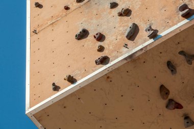 Dışarıdaki yıpranmış duvara tırmanıyorum. Kaya parkına rağmen. Park 'taki yapay kaya tırmanma duvarı.